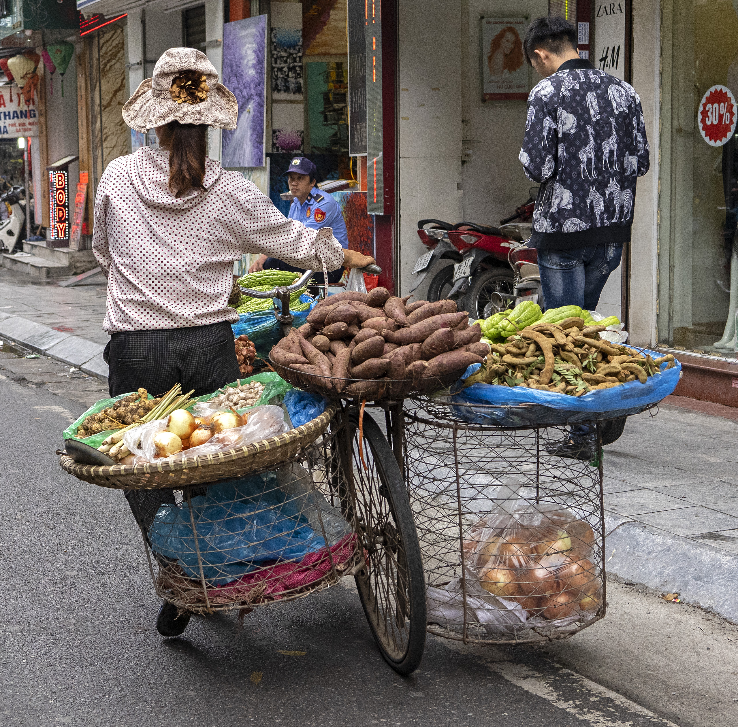 Ha Noi, woman selling produce on bike